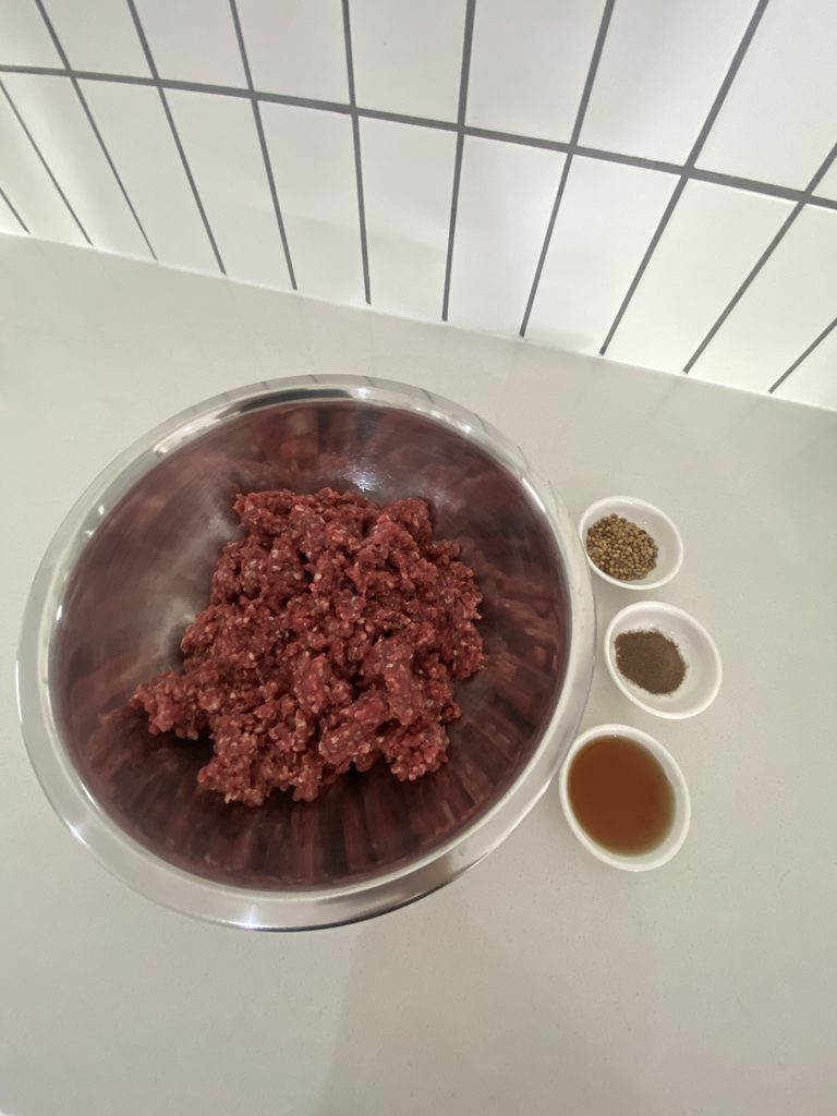 Ingredients for homemade high-protein trail snack with ground beef and spices
